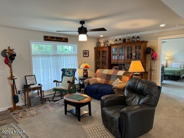 living room featuring carpet flooring and ceiling fan