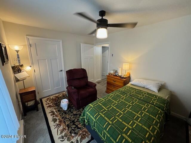 bedroom with ceiling fan and dark colored carpet