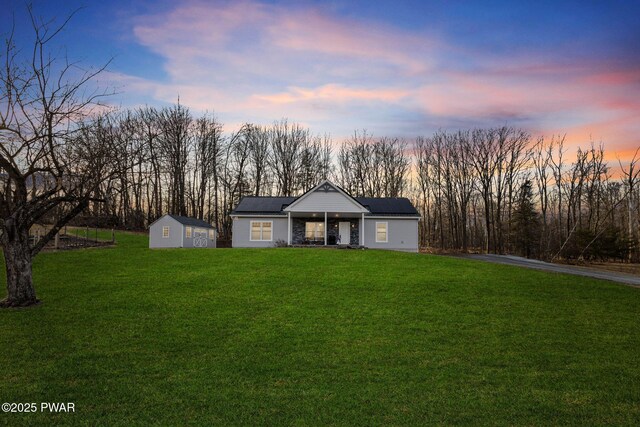 rear view of house with a patio area, a yard, and solar panels