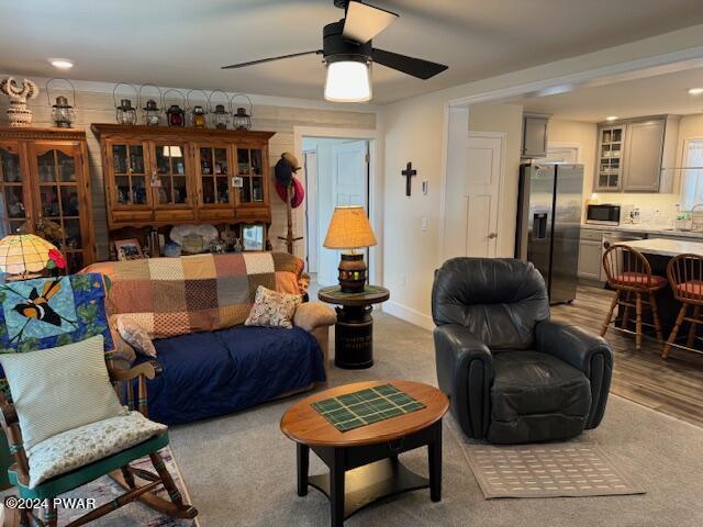 living room featuring ceiling fan and sink