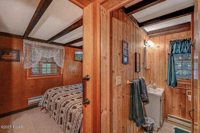 25 Deerfoot Rd, Lake Ariel, PA 18436 - carpeted bedroom featuring baseboard heating, a baseboard radiator, wood walls, beam ceiling, and a sink