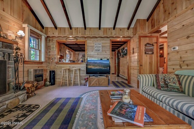 25 Deerfoot Rd, Lake Ariel, PA 18436 - living room featuring wood walls, carpet floors, heating unit, a glass covered fireplace, and baseboard heating