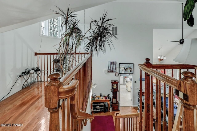 stairs featuring a high ceiling and wood finished floors