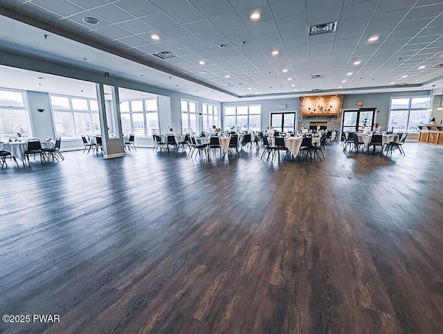 exercise room featuring visible vents, wood finished floors, and a healthy amount of sunlight