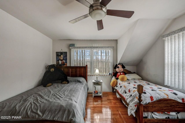 bedroom with wood finished floors, ceiling fan, and vaulted ceiling