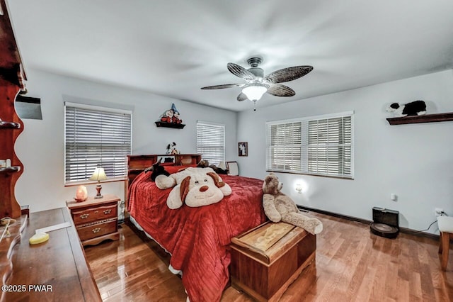 bedroom with wood finished floors, ceiling fan, and baseboards