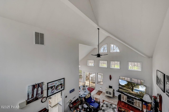 living area with visible vents, high vaulted ceiling, and a ceiling fan