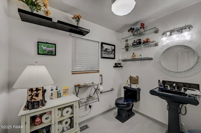 half bathroom featuring toilet and baseboards