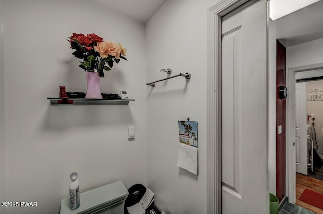 clothes washing area featuring wood finished floors