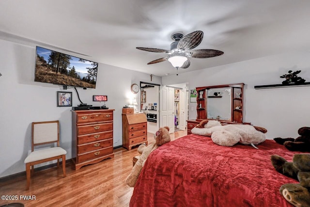 bedroom with light wood-style flooring and a ceiling fan
