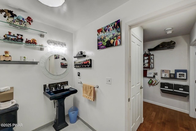 bathroom featuring wood finished floors and baseboards