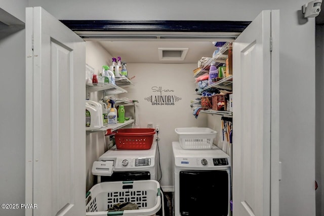 clothes washing area with washing machine and dryer and laundry area