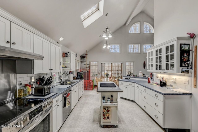 kitchen featuring open shelves, a sink, dark countertops, under cabinet range hood, and stainless steel appliances
