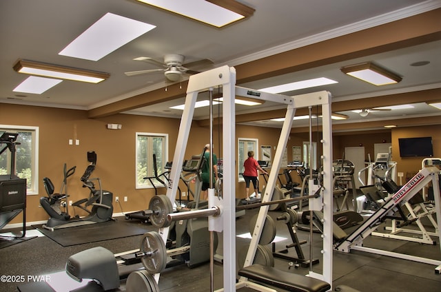 gym with ceiling fan, baseboards, crown molding, and a healthy amount of sunlight