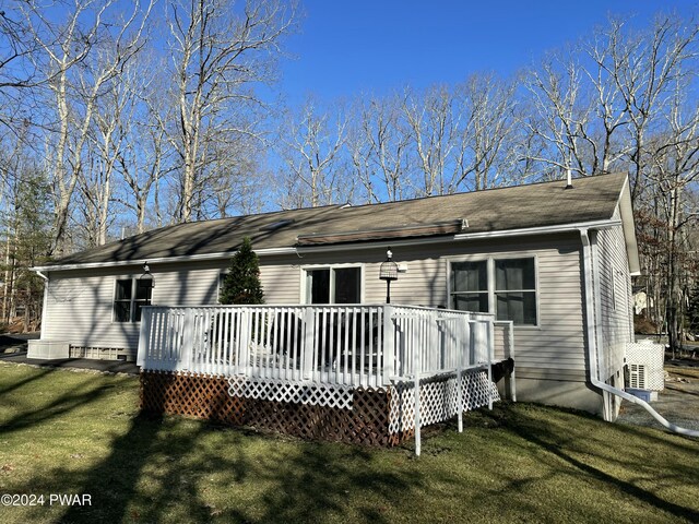 back of house featuring a yard and a deck