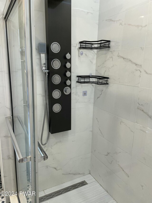 bathroom with a tile shower