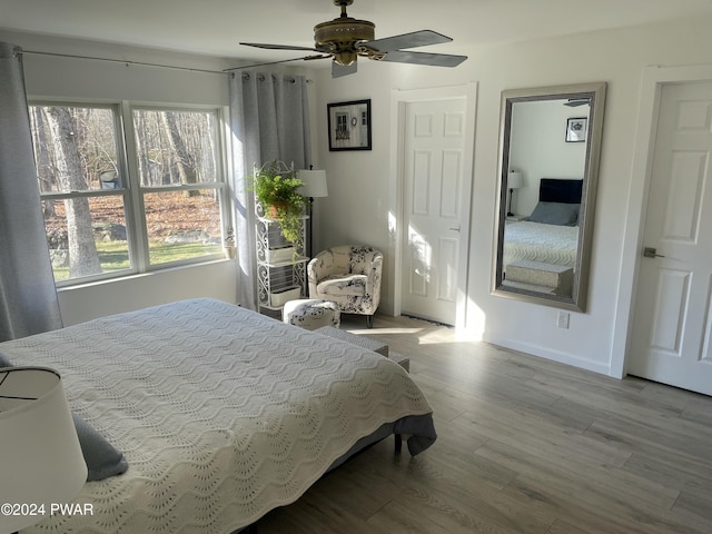 bedroom featuring ceiling fan and light hardwood / wood-style flooring