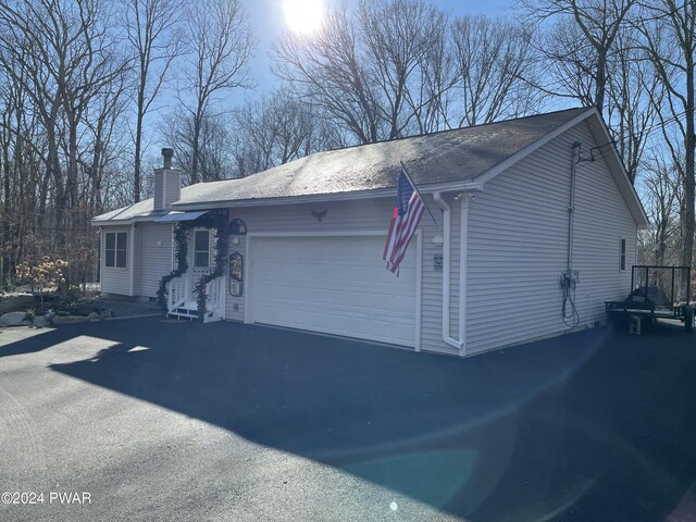 view of side of property with a garage