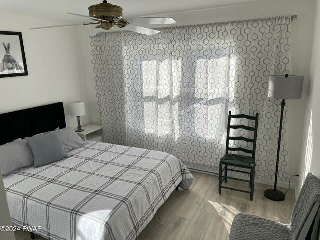 bedroom with ceiling fan and hardwood / wood-style floors