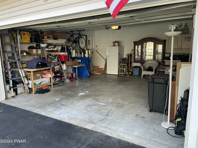 garage featuring white fridge