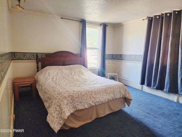 carpeted bedroom featuring crown molding and a textured ceiling