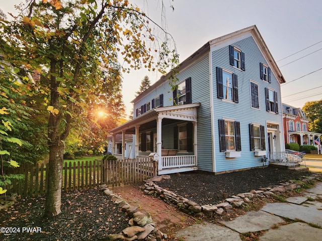 property exterior at dusk with covered porch