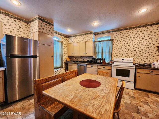 kitchen with appliances with stainless steel finishes and crown molding