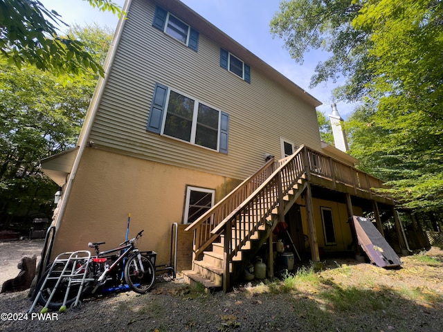 back of house featuring a deck