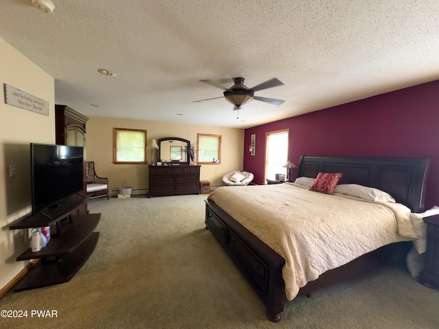 bedroom featuring carpet flooring, a textured ceiling, and ceiling fan