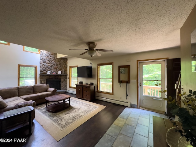 living room with a fireplace, a textured ceiling, a baseboard radiator, and ceiling fan