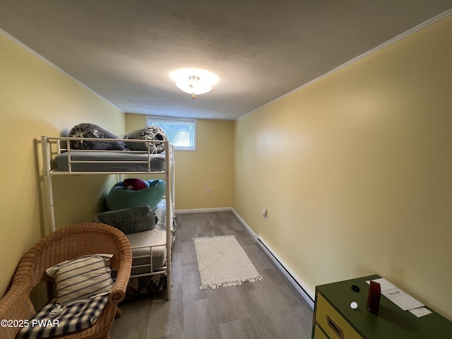 129 Waterview Dr, Lords Valley, PA 18428 - bedroom with baseboards, a baseboard radiator, wood finished floors, and ornamental molding