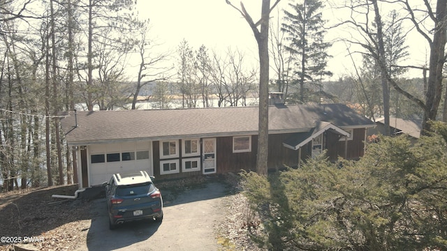 129 Waterview Dr, Lords Valley, PA 18428 - view of front of property featuring a shingled roof, board and batten siding, an attached garage, and aphalt driveway