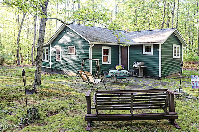138 Lake Minisink Rd E, Dingmans Ferry, PA 18328 - back of house featuring roof with shingles and a patio area