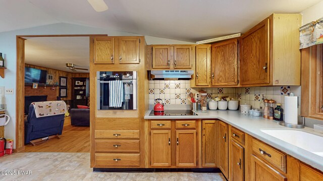 163 Wild Acres Dr, Dingmans Ferry, PA 18328 - kitchen featuring stainless steel oven, under cabinet range hood, black electric cooktop, a ceiling fan, and light countertops
