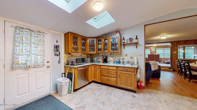 163 Wild Acres Dr, Dingmans Ferry, PA 18328 - kitchen with stainless steel appliances, a skylight, light countertops, lofted ceiling, and brown cabinetry