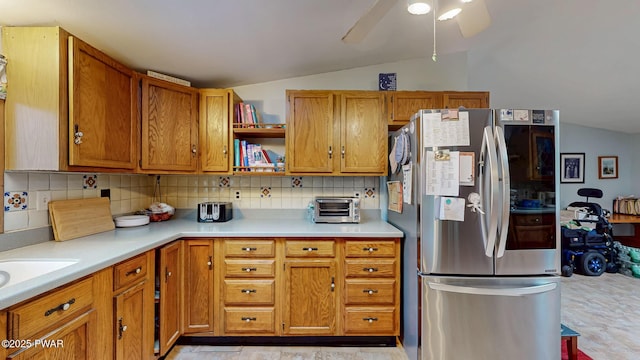 163 Wild Acres Dr, Dingmans Ferry, PA 18328 - kitchen with smart refrigerator, lofted ceiling, tasteful backsplash, light countertops, and brown cabinets