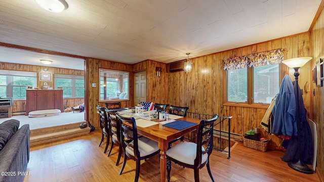 163 Wild Acres Dr, Dingmans Ferry, PA 18328 - dining room with wood walls, wood finished floors, and baseboard heating