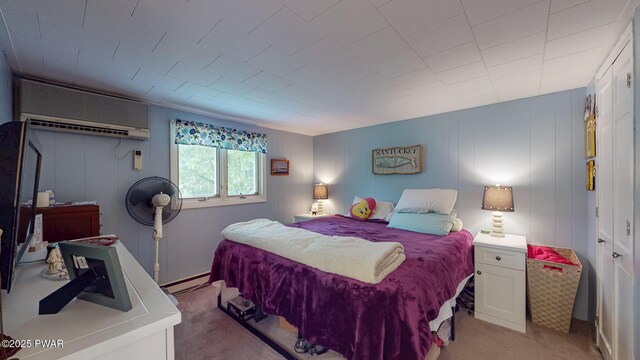 163 Wild Acres Dr, Dingmans Ferry, PA 18328 - bedroom with an AC wall unit, light colored carpet, and a baseboard heating unit
