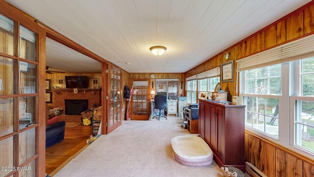 163 Wild Acres Dr, Dingmans Ferry, PA 18328 - office space featuring wooden walls, plenty of natural light, a fireplace, and baseboard heating
