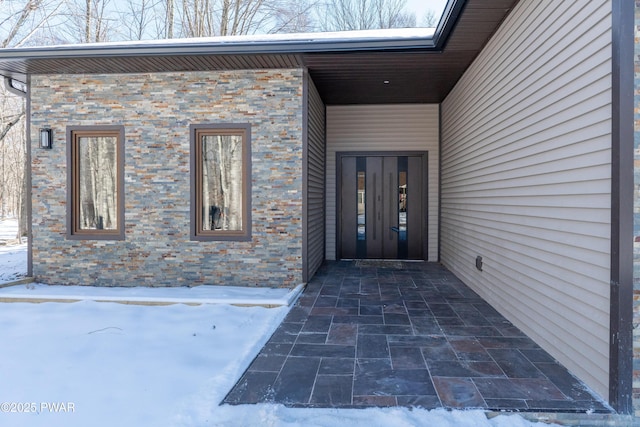 view of snow covered property entrance