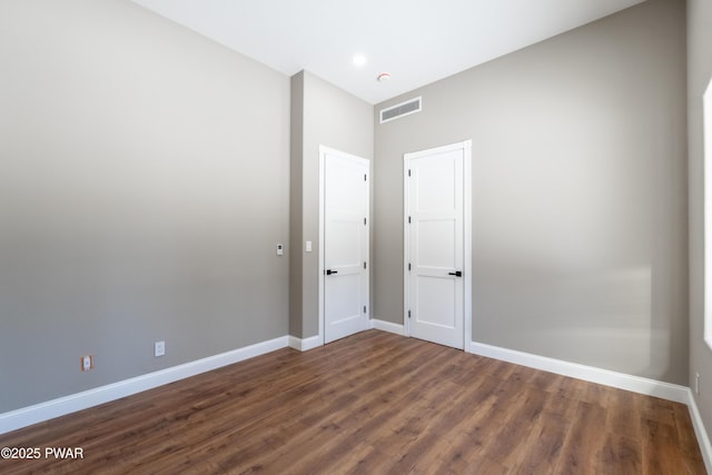 spare room featuring dark hardwood / wood-style floors