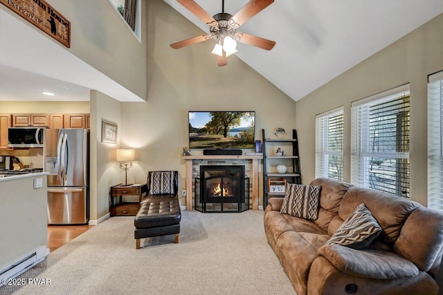 102 Oriole Pl, Lackawaxen, PA 18435 - living room featuring baseboards, a ceiling fan, a baseboard heating unit, a glass covered fireplace, and light carpet