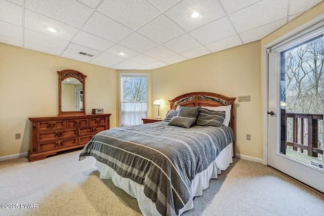 bedroom with a paneled ceiling and carpet