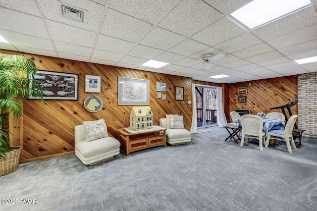 sitting room with carpet and a paneled ceiling