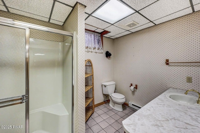 bathroom featuring tile patterned flooring, a paneled ceiling, a baseboard radiator, and a shower with shower door