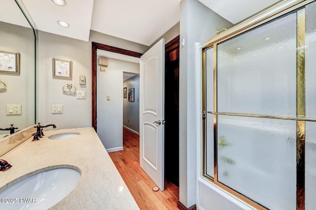 bathroom featuring shower / bath combination with glass door, vanity, and hardwood / wood-style flooring