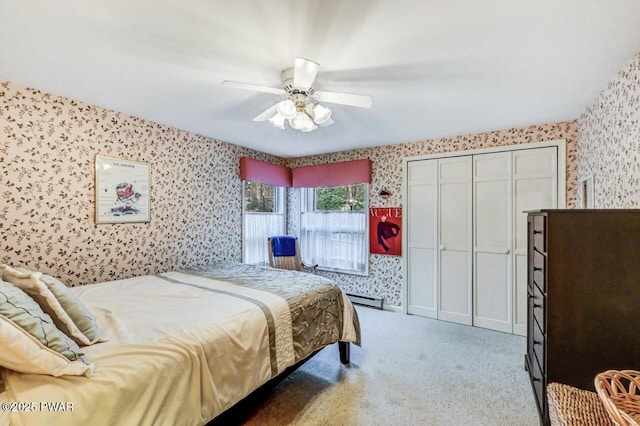 carpeted bedroom featuring ceiling fan and a baseboard radiator