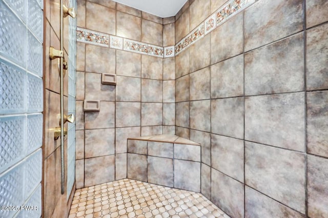 bathroom with a tile shower