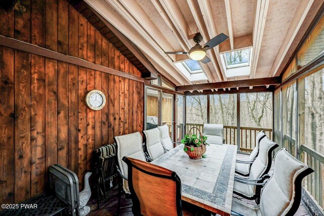 sunroom with ceiling fan and lofted ceiling