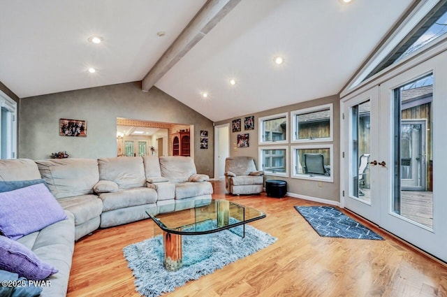 living room with french doors, lofted ceiling with beams, and light hardwood / wood-style floors